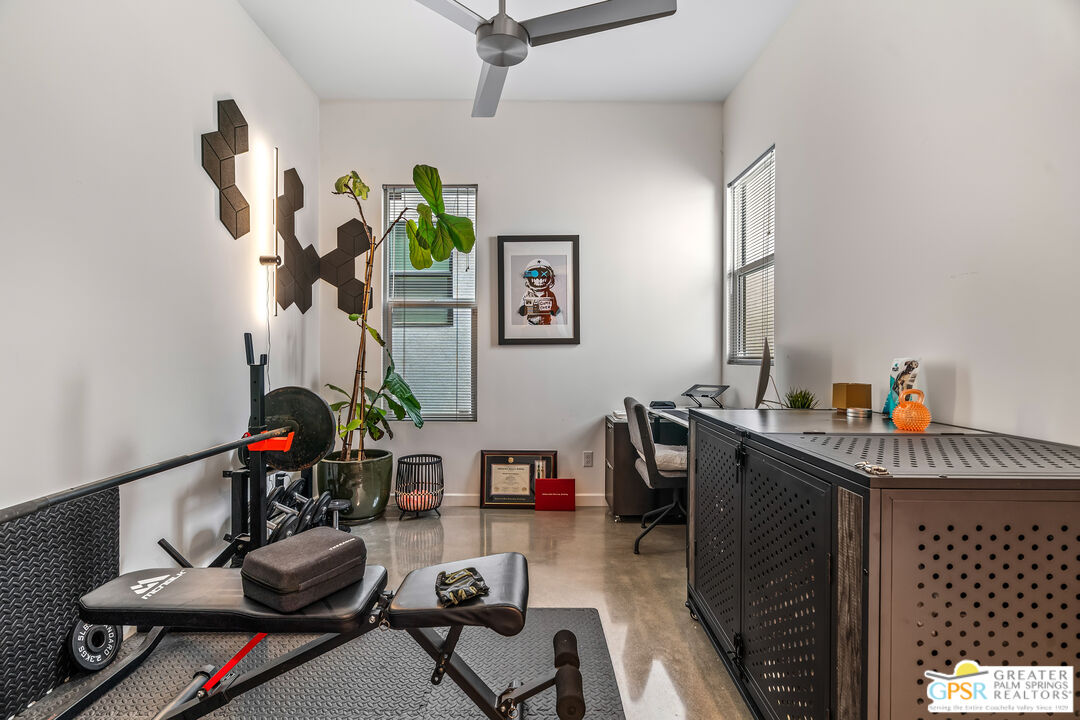 482 Paragon Loop Palm Springs, CA 92262 - Photo 12 of 24 a living room with furniture and a gym equipment