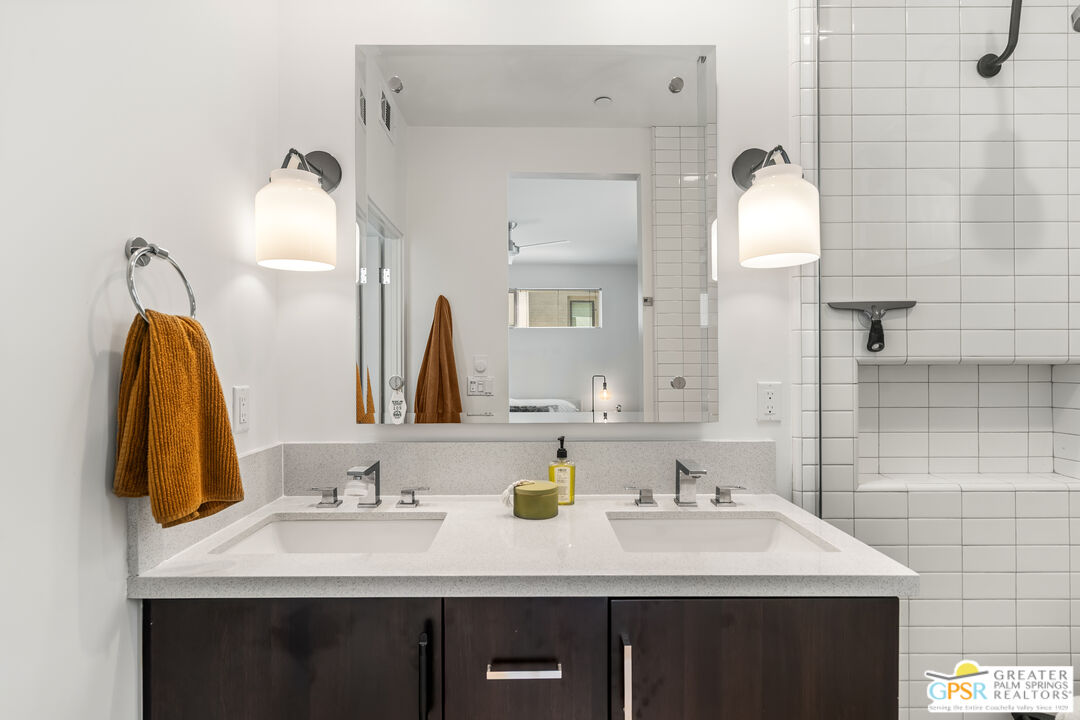 482 Paragon Loop Palm Springs, CA 92262 - Photo 14 of 24 a bathroom with a double vanity sink and a mirror
