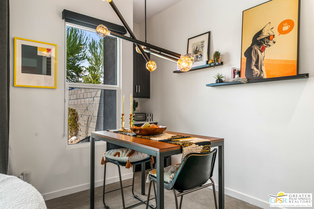 482 Paragon Loop Palm Springs, CA 92262 - Photo 5 of 24 a view of a dining room with furniture and a window