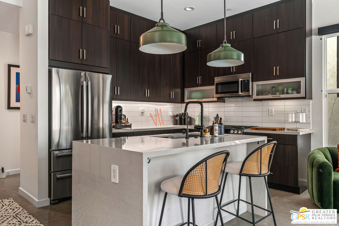 482 Paragon Loop Palm Springs, CA 92262 - Photo 6 of 24 a kitchen with stainless steel appliances granite countertop a sink a stove and a refrigerator