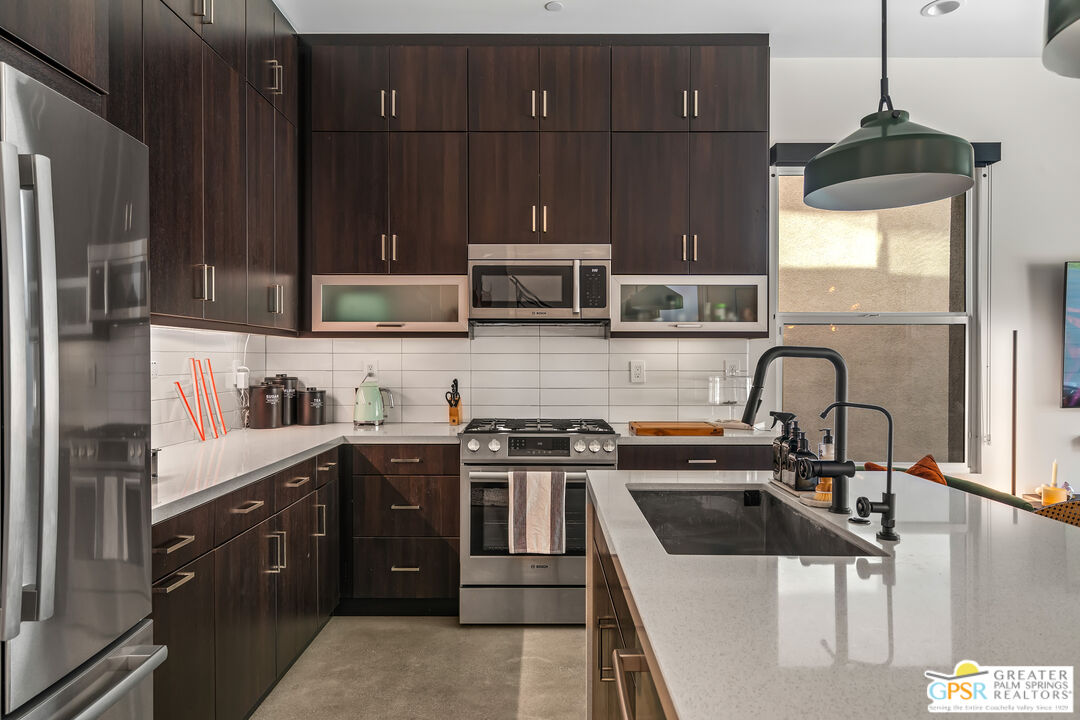 482 Paragon Loop Palm Springs, CA 92262 - Photo 10 of 24 a kitchen with a stove a sink and a refrigerator