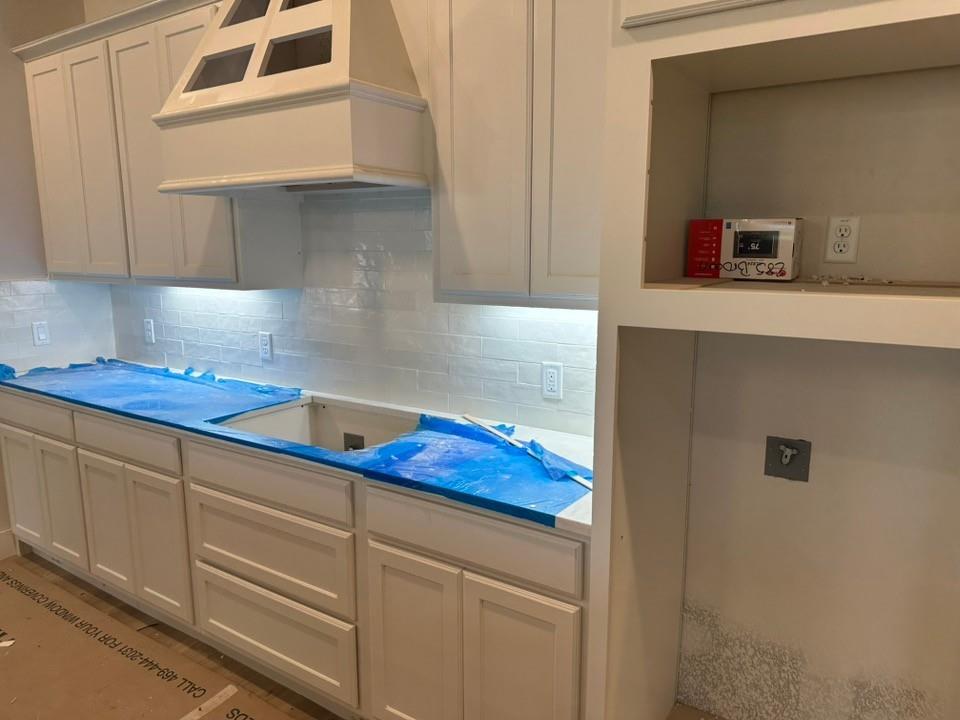 585 Brown Road Leonard, TX 75452 - Photo 11 of 29 Kitchen featuring white shaker-style cabinetry, a custom range hood, subway tile backsplash, under-cabinet lighting, and built-in shelving