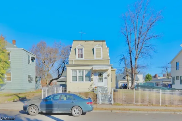 a front view of a house with parking area