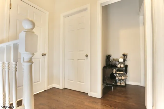 a view of a hallway with wooden floor and a livingroom view