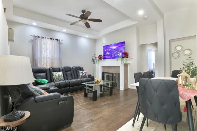 a living room with fireplace furniture and a wooden floor