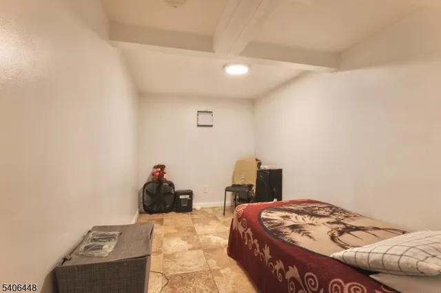 a bedroom with a bed and a lamp with the wall