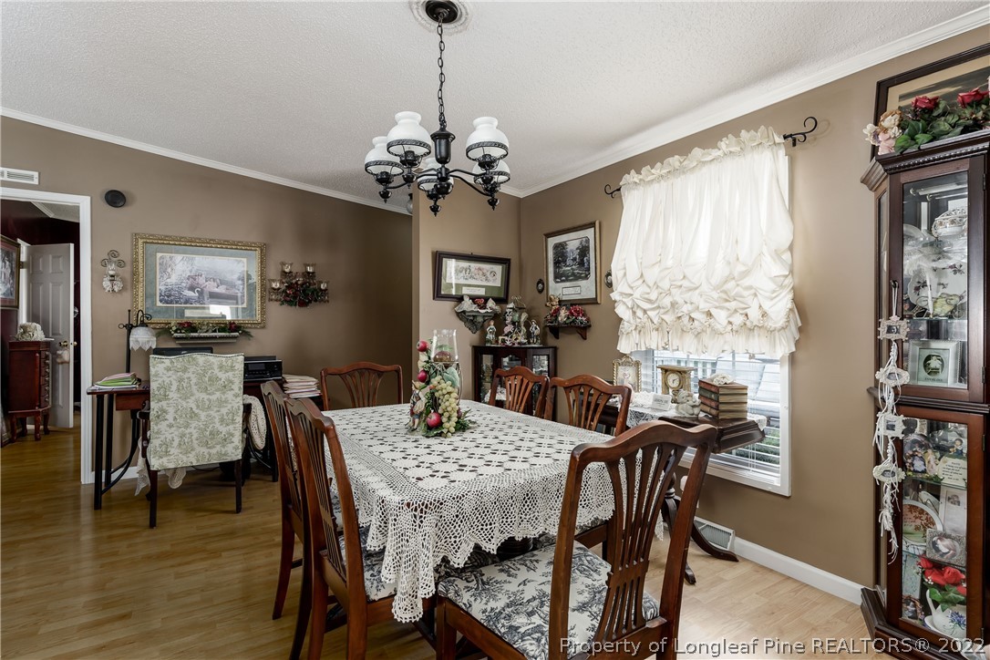 450 Bibey Road Carthage, NC 28327 - Photo 26 of 36 a view of a dining room with furniture window and wooden floor