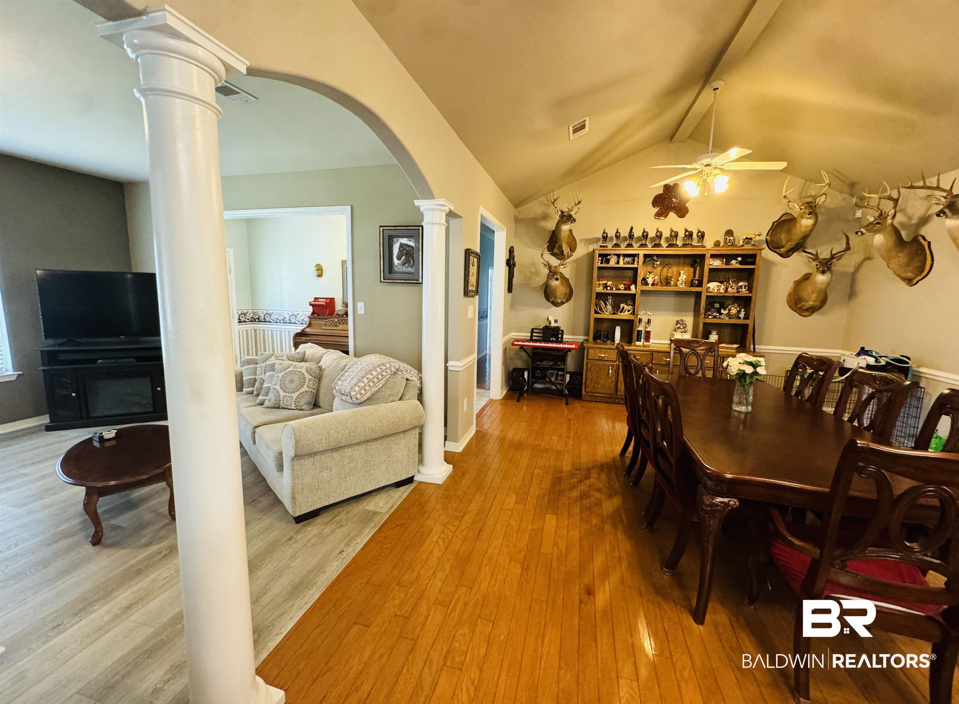 13795 White Road Silverhill, AL 36576 - Photo 25 of 99 Dining room with light wood finished floors, arched walkways, beam ceiling, decorative columns, and a ceiling fan