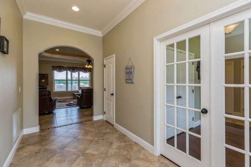 4595 Hermosa Road Crestview, FL 32539 - Photo 4 of 35 a view of a hallway with wooden floor and a bathroom