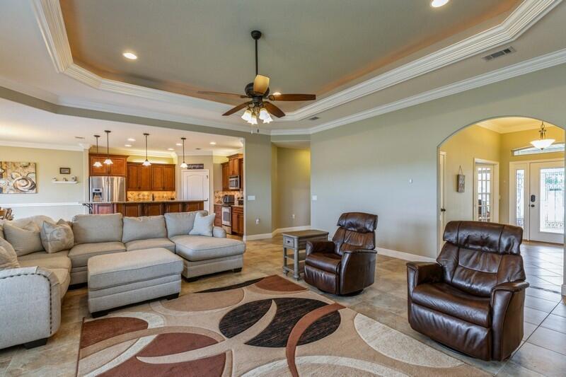 4595 Hermosa Road Crestview, FL 32539 - Photo 5 of 35 a living room with furniture ceiling fan and a rug