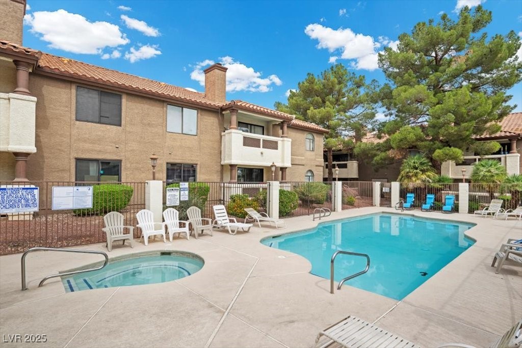 2995 East Sunset Road, Unit 134 Las Vegas, NV 89120 - Photo 19 of 20 Community pool with a patio area and a hot tub!