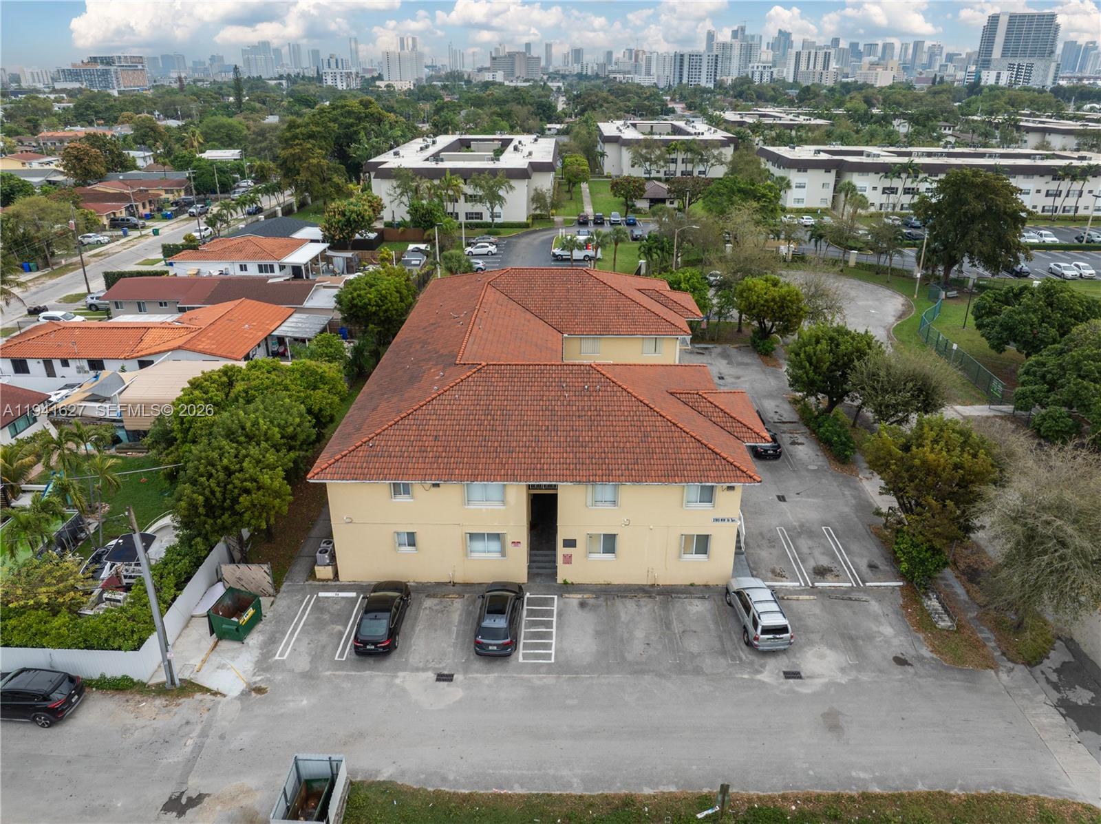 an aerial view of a house with a garden and lake view