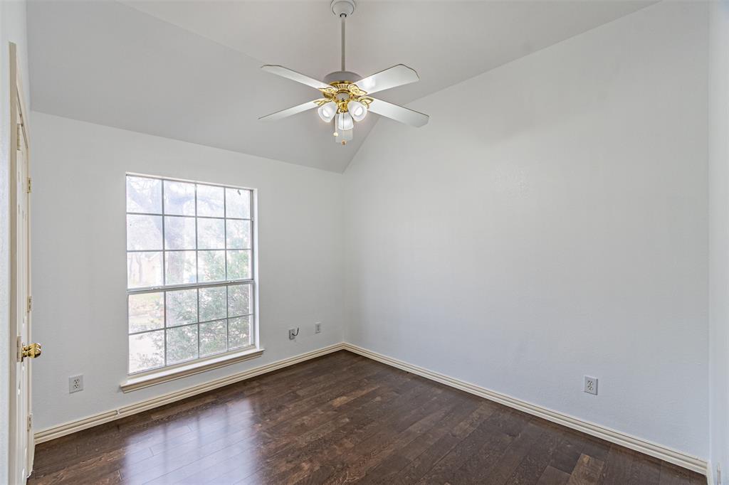 1907 New Haven Road Grapevine, TX 76051 - Photo 19 of 34 an empty room with windows and chandelier fan