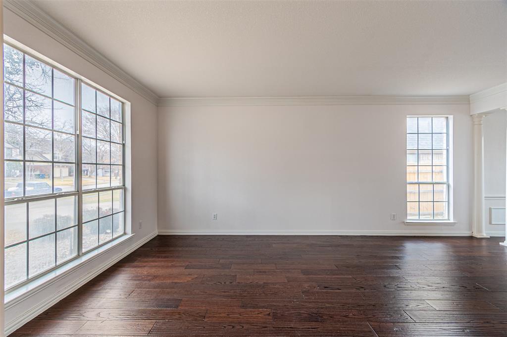 1907 New Haven Road Grapevine, TX 76051 - Photo 24 of 34 an empty room with wooden floor and windows with curtains view