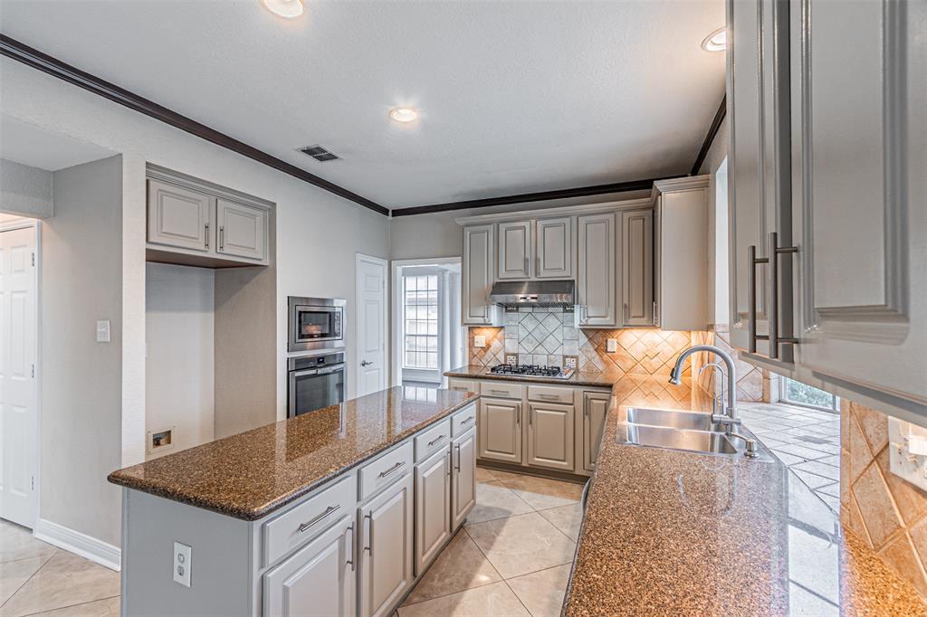 1907 New Haven Road Grapevine, TX 76051 - Photo 7 of 34 a kitchen with granite countertop a sink stove and cabinets