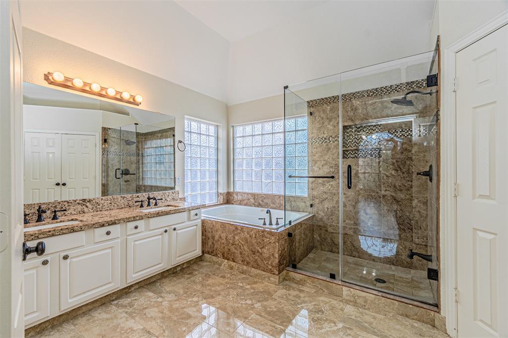 1907 New Haven Road Grapevine, TX 76051 - Photo 9 of 34 a spacious bathroom with a shower sink and mirror