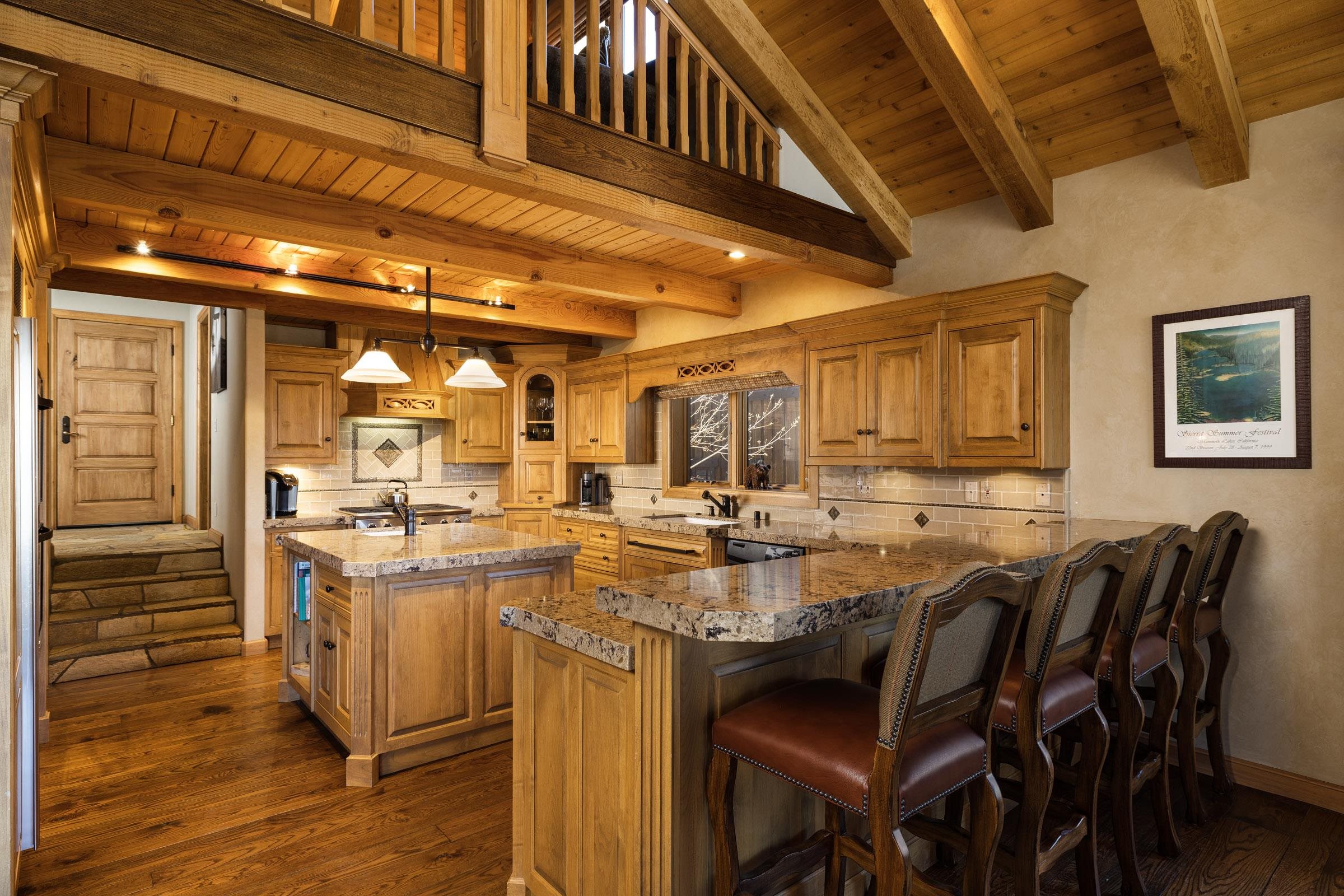 285 Juniper Road Mammoth Lakes, CA 93546 - Photo 13 of 38 a kitchen with lots of wooden cabinets appliances and furniture