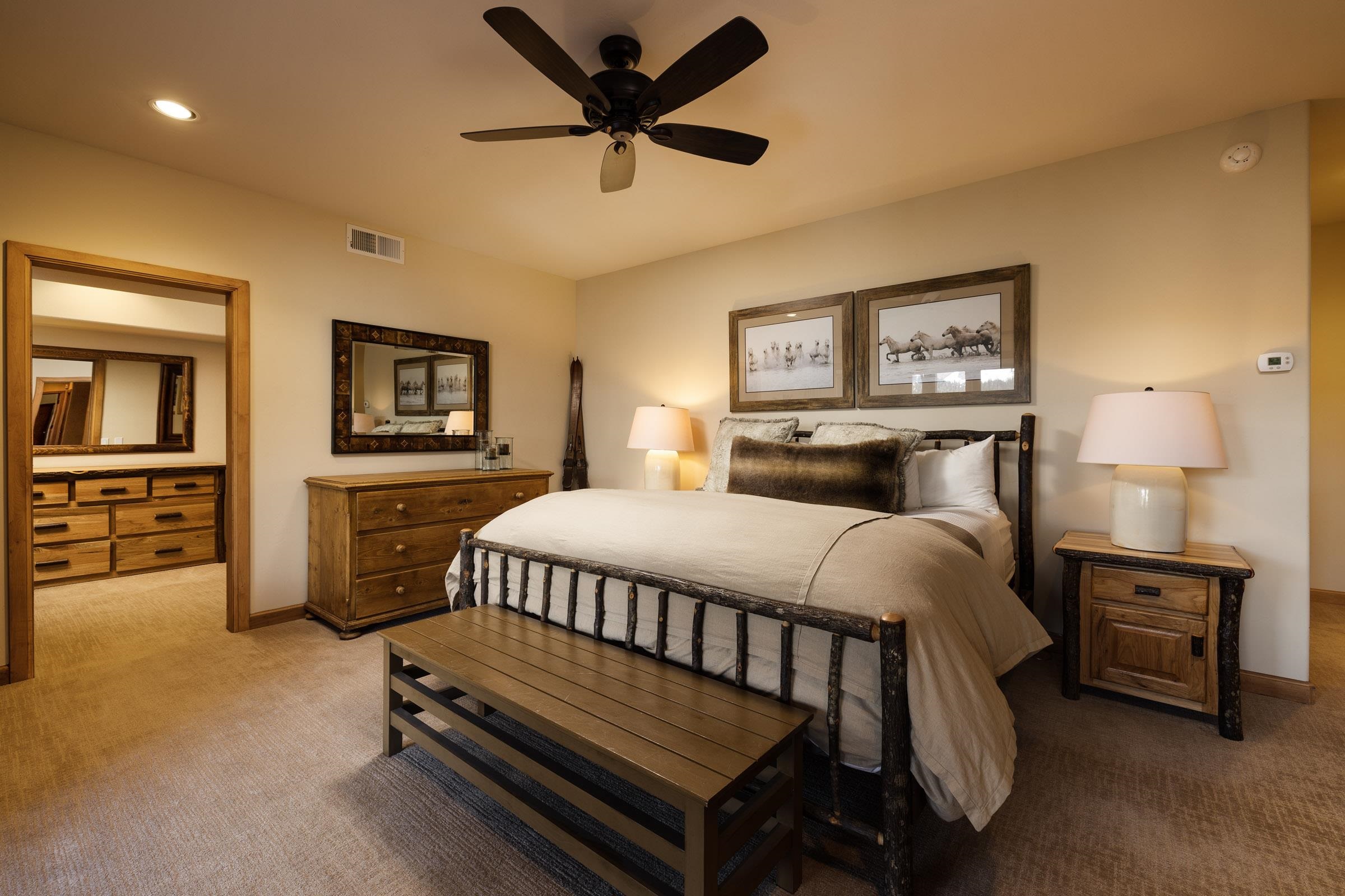 285 Juniper Road Mammoth Lakes, CA 93546 - Photo 27 of 38 a bedroom with a bed and a chandelier