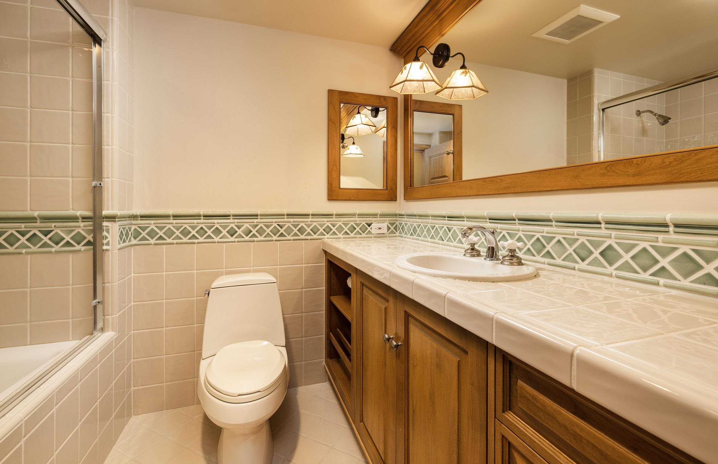 285 Juniper Road Mammoth Lakes, CA 93546 - Photo 28 of 38 a bathroom with a granite countertop sink and a mirror