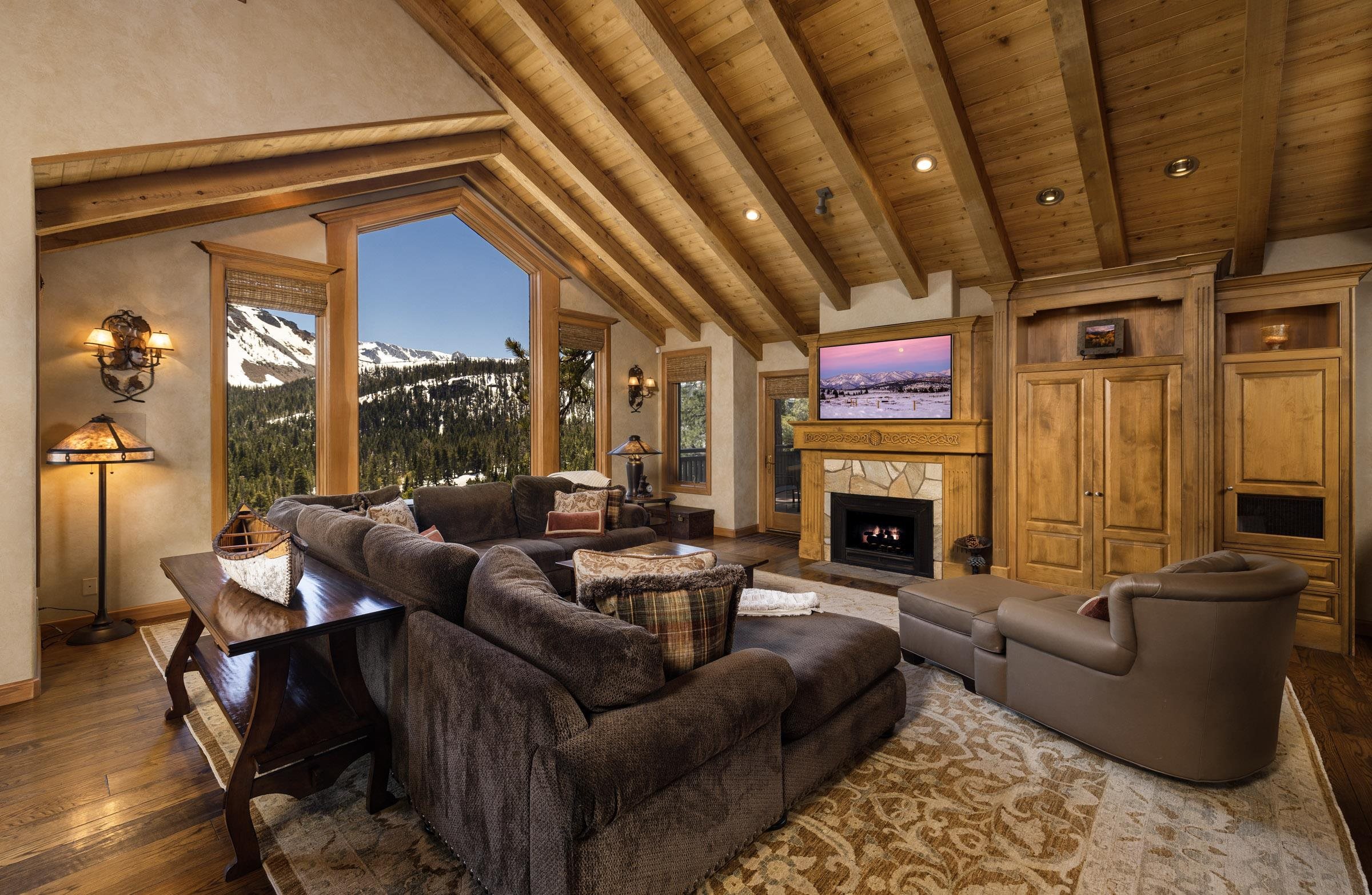285 Juniper Road Mammoth Lakes, CA 93546 - Photo 5 of 38 a living room with furniture a fireplace and a table