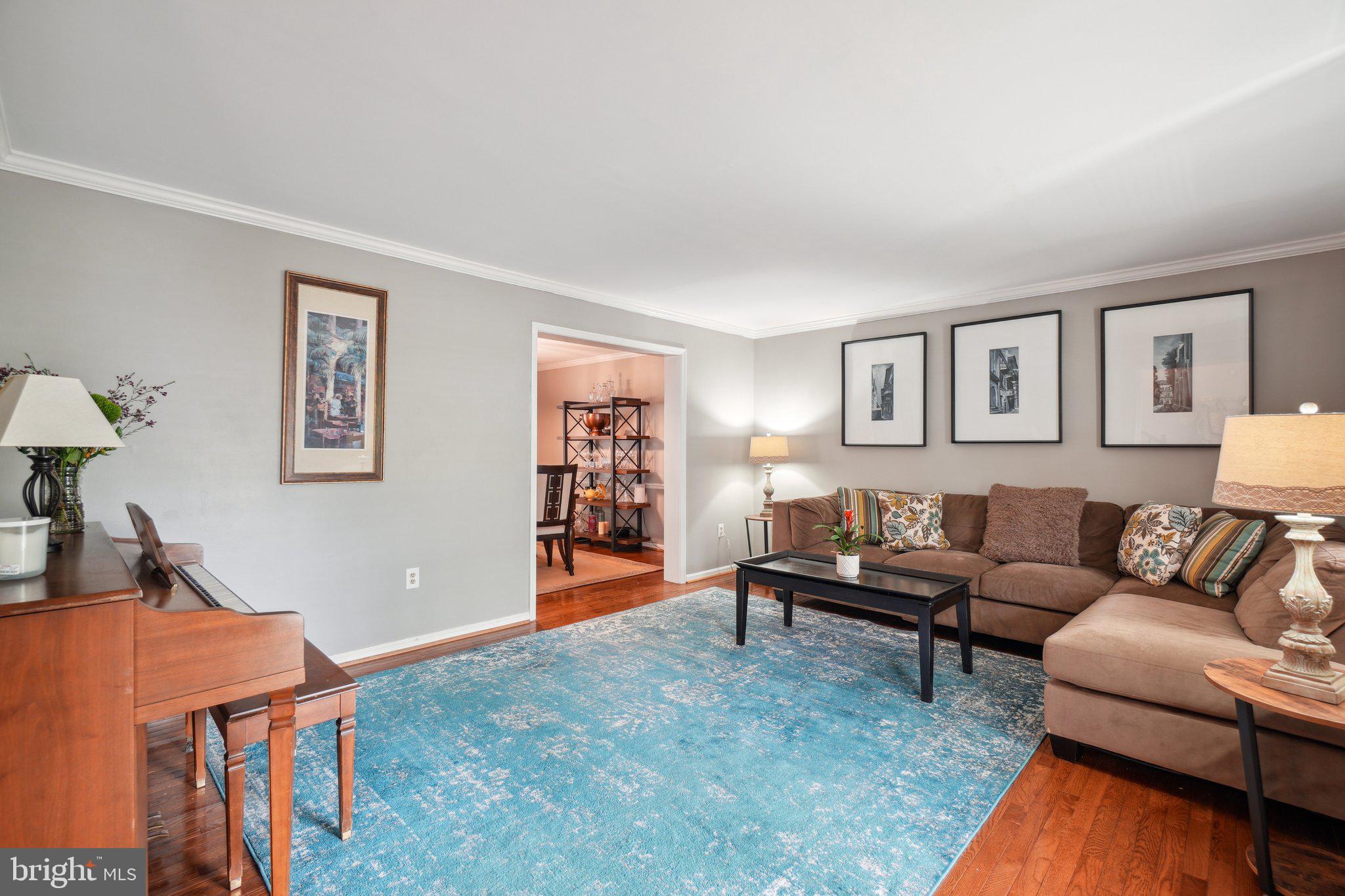 10604 Cannonview Court Fort Washington, MD 20744 - Photo 12 of 50 a living room with furniture a desk and chair with wooden floor