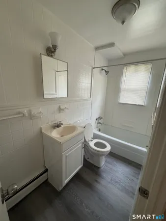 a bathroom with a sink a bathtub and a shower