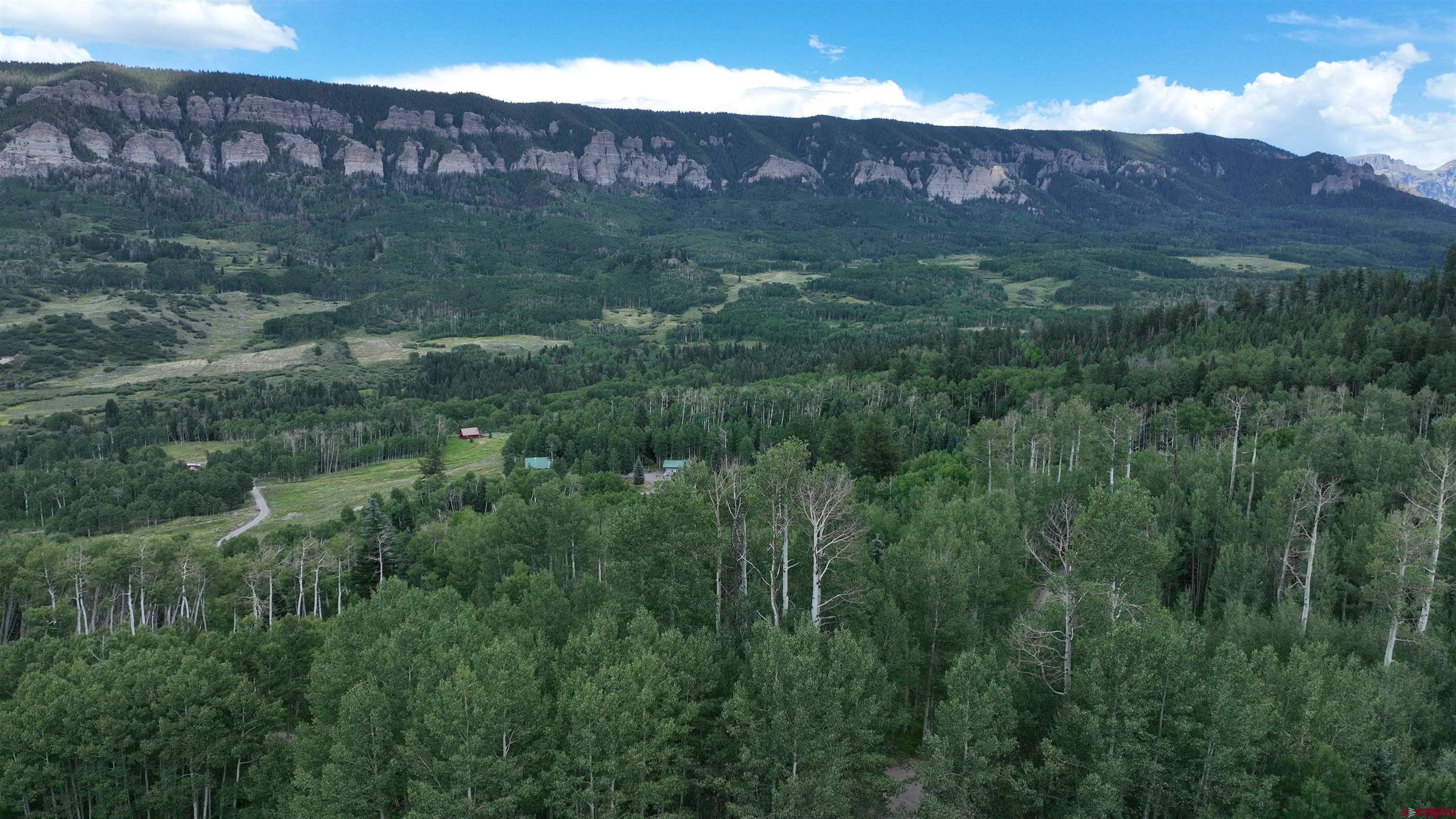 1073 Hampton Road Montrose, CO 81403 - Photo 14 of 26 a view of a lush green hillside and a building