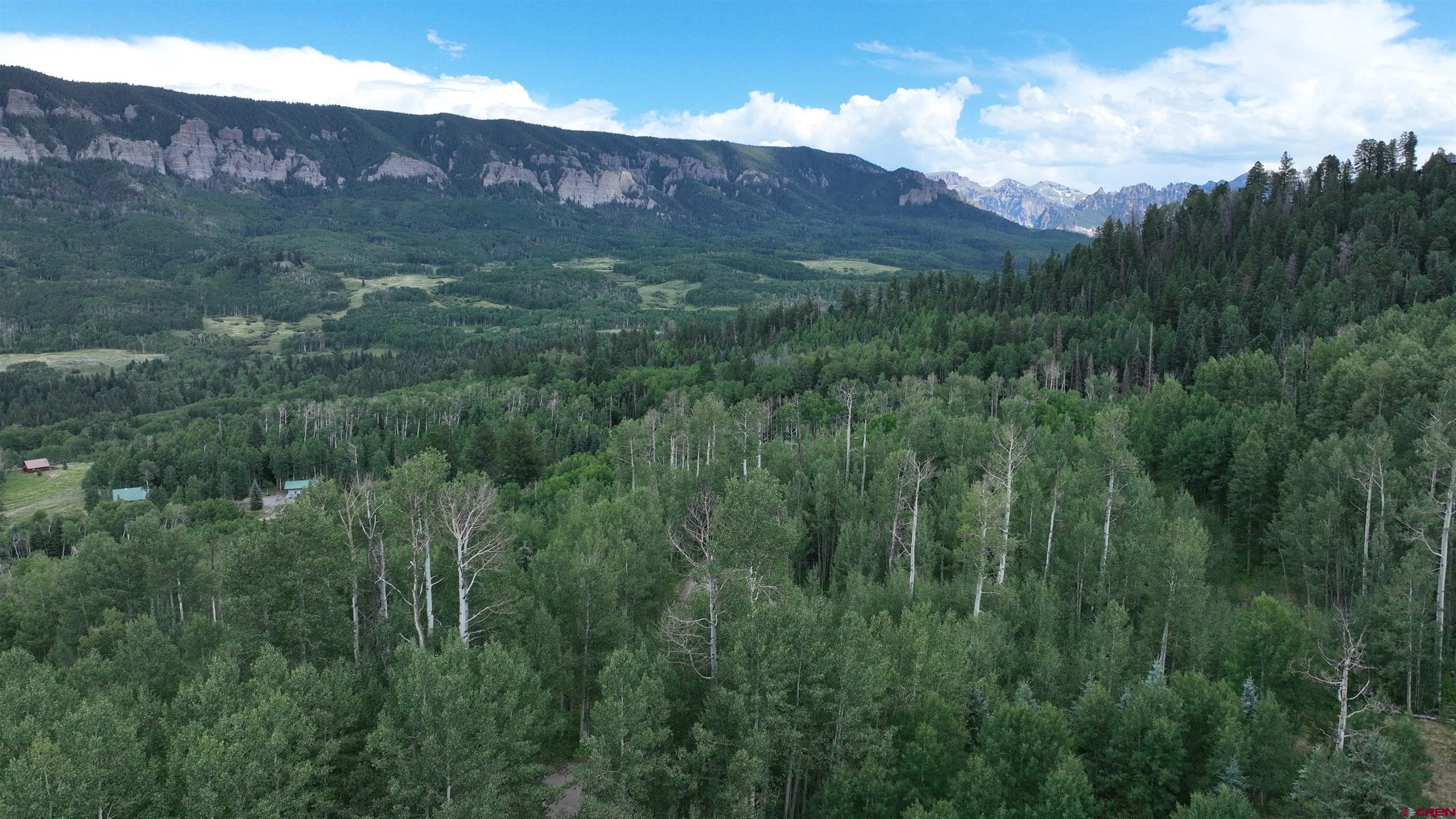 1073 Hampton Road Montrose, CO 81403 - Photo 15 of 26 a view of a lush green hillside and a building