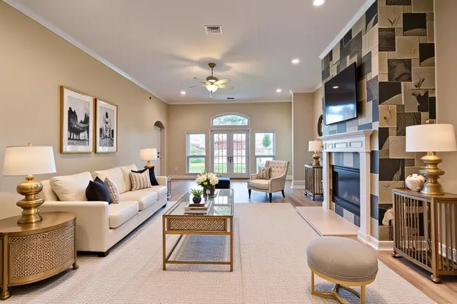 a living room with fireplace furniture and a large window