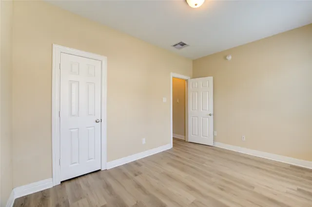 an empty room with wooden floor