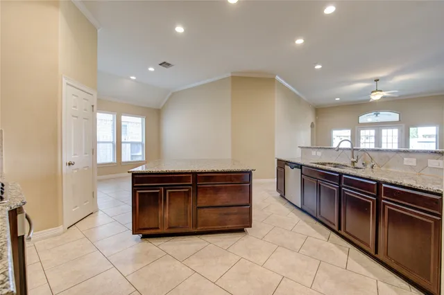 a kitchen with stainless steel appliances granite countertop a stove and a sink