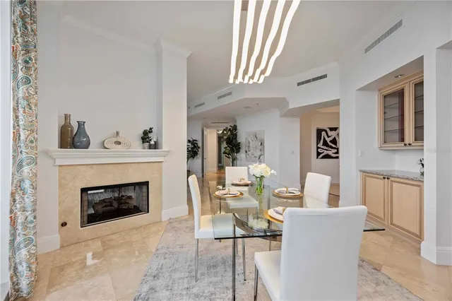 a living room with furniture flowerpot and a chandelier