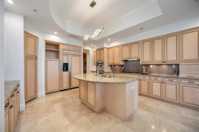 a kitchen with stainless steel appliances granite countertop a sink and cabinets