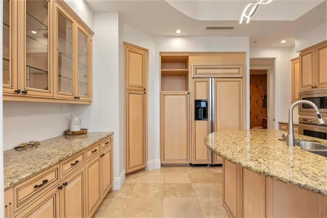 a large kitchen with a stove and a sink