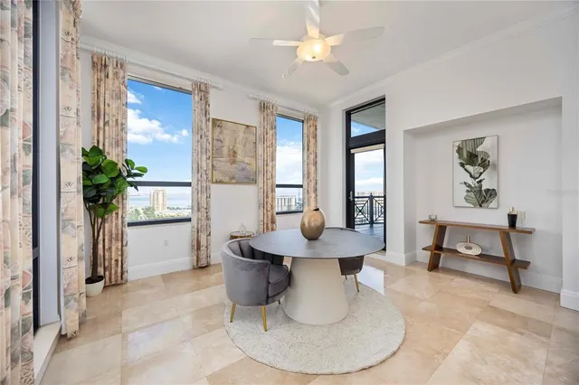 a dining room with furniture and a chandelier