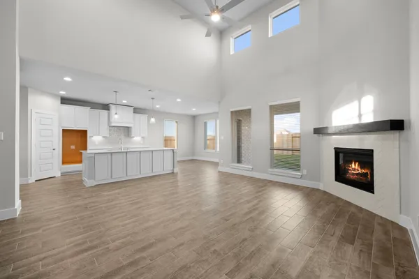 a view of an empty room with a fireplace and window