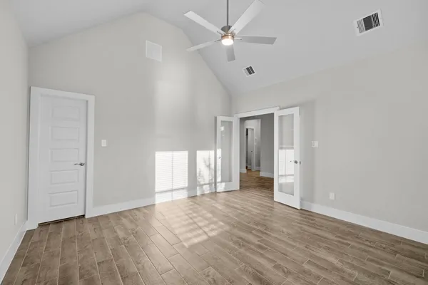 wooden floor in an empty room with a window