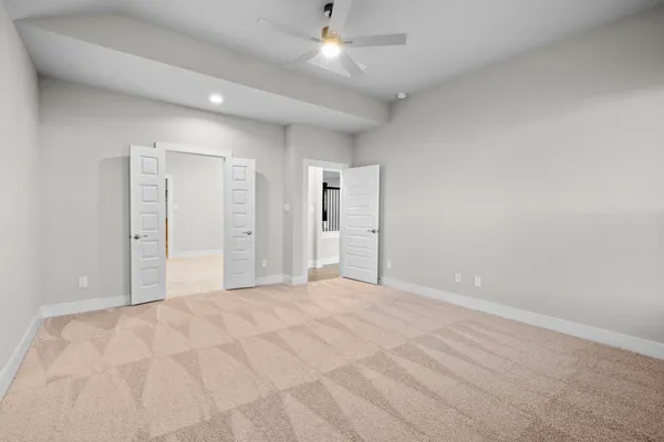 a view of an empty room with a ceiling fan