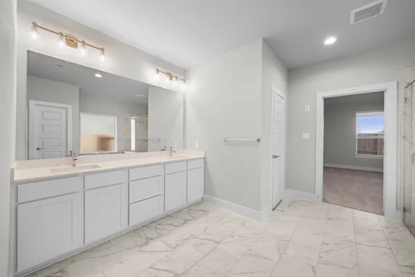a spacious bathroom with a mirror vanity and shower