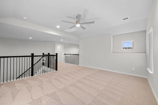 a view of a hallway with a ceiling fan