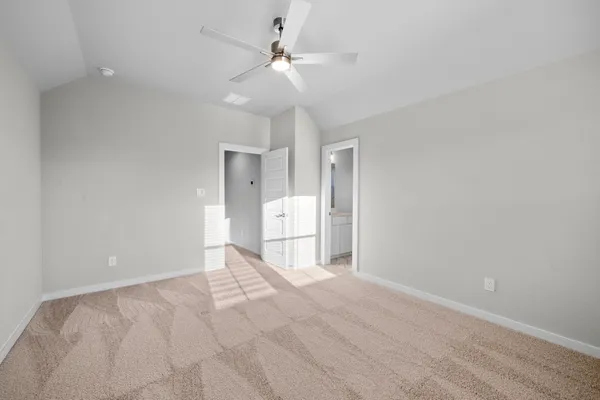 a view of an empty room with a ceiling fan