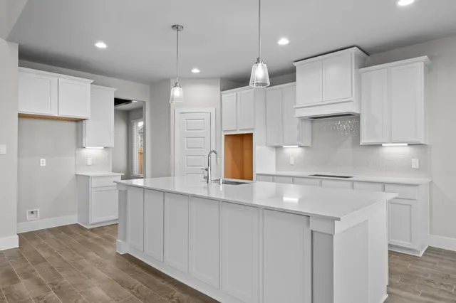 a kitchen with kitchen island a sink stainless steel appliances and cabinets