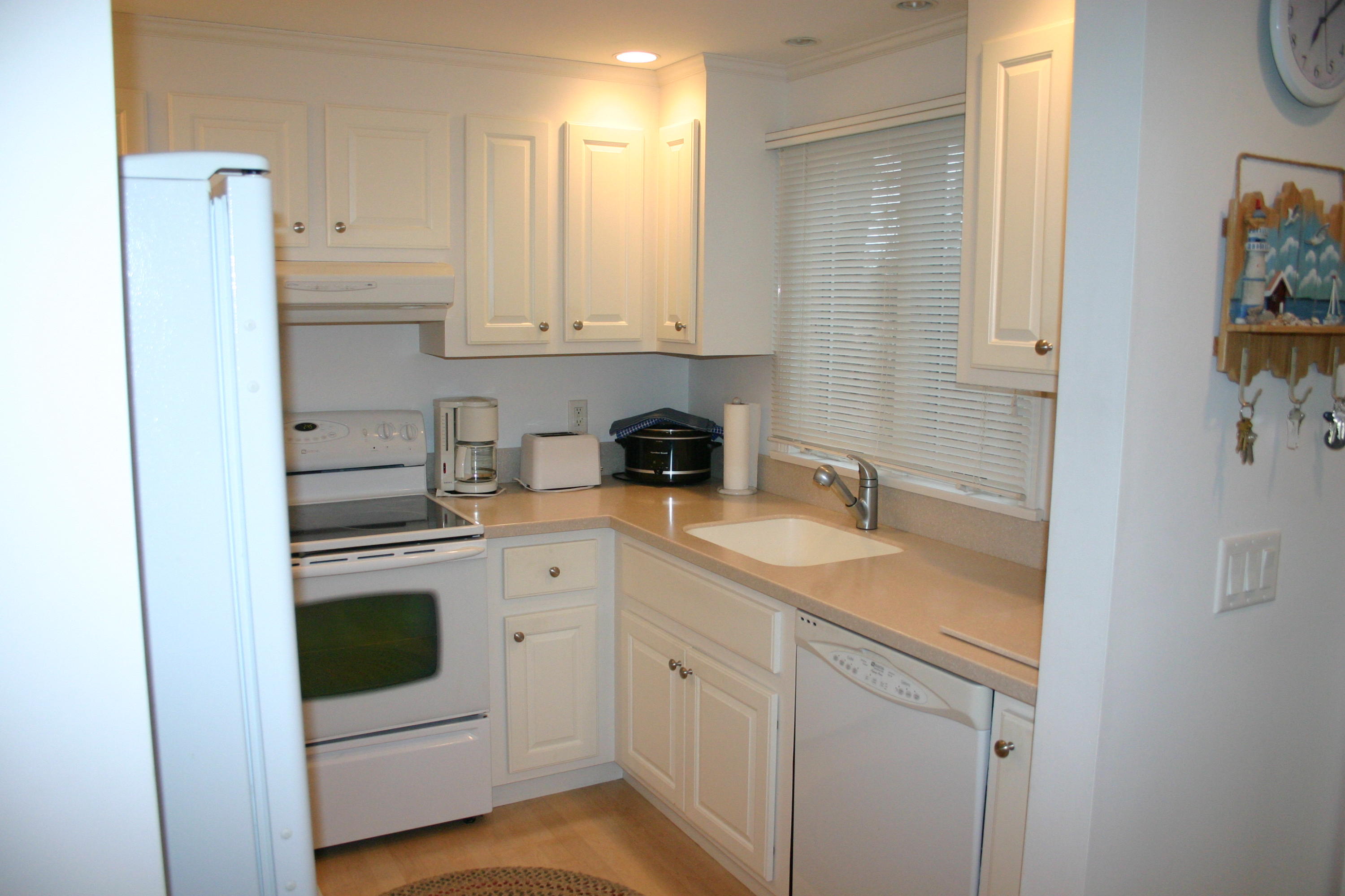 93 Depot Road, Unit 10 Chatham, MA 02633 - Photo 12 of 16 a kitchen with a sink and cabinets