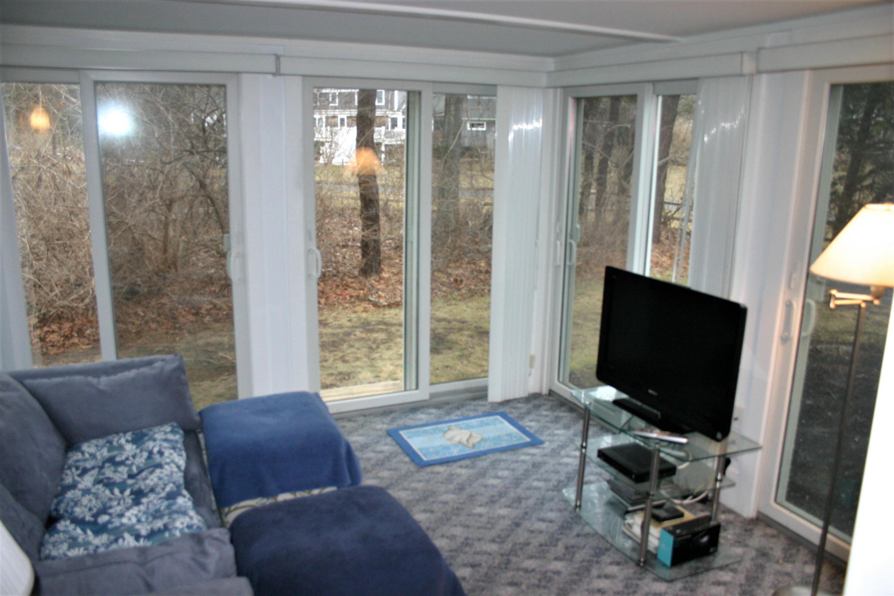 93 Depot Road, Unit 10 Chatham, MA 02633 - Photo 10 of 16 a living room with furniture and a flat screen tv