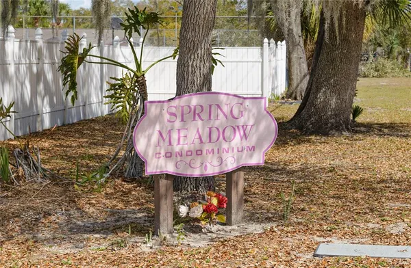 a picture of a table and chairs with wooden fence