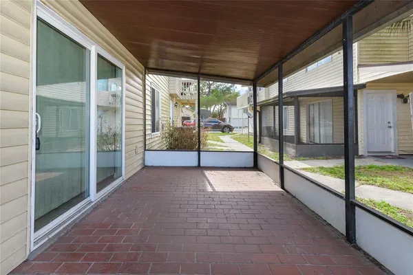 a view of an empty room with sliding glass door