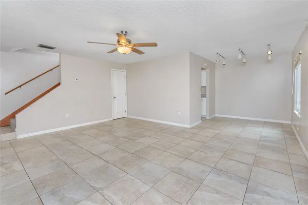 an empty room with closet and a ceiling fan