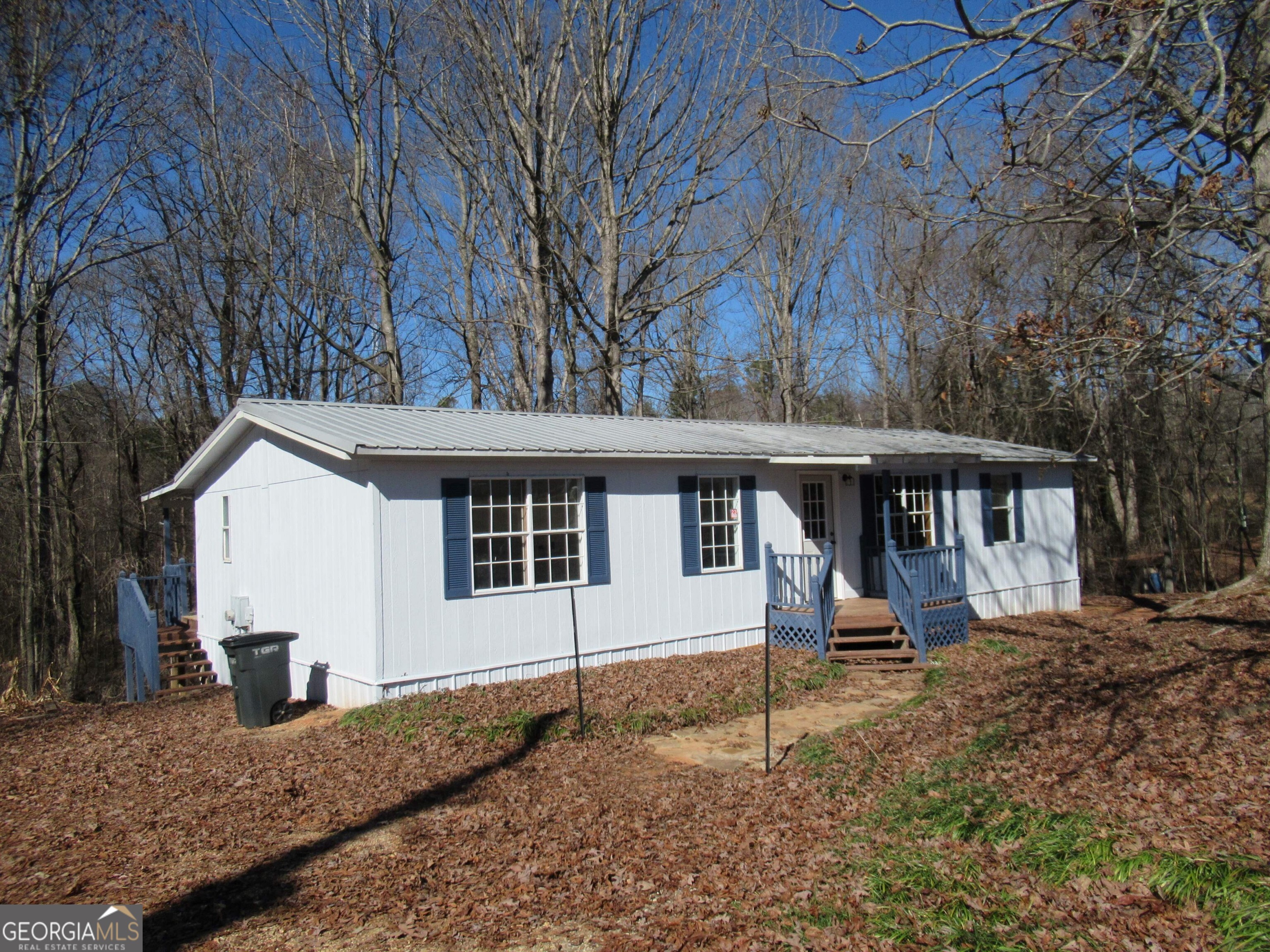 1729 New Bridge Road Cleveland, GA 30528 - Photo 1 of 1 a front view of a house with garden