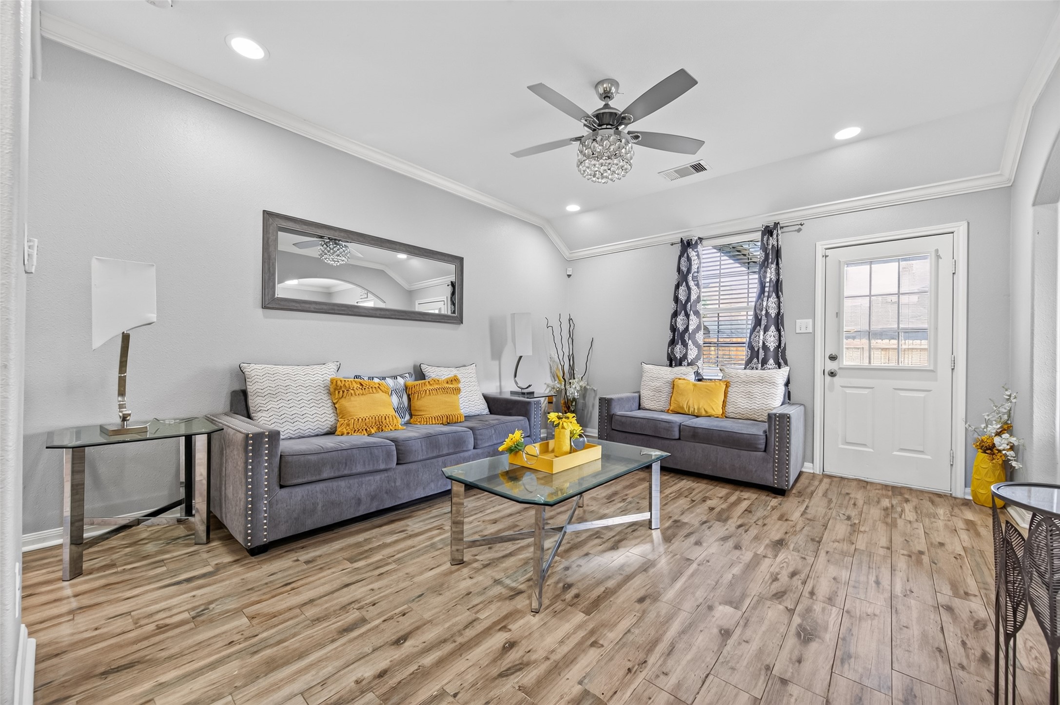 3418 Lockgate Drive Spring, TX 77388 - Photo 10 of 47 This bright and airy living room offers comfortable seating and a stylish ceiling fan for year-round comfort. A door leads directly to the backyard, allowing for easy indoor-outdoor flow, while large windows fill the space with natural light.