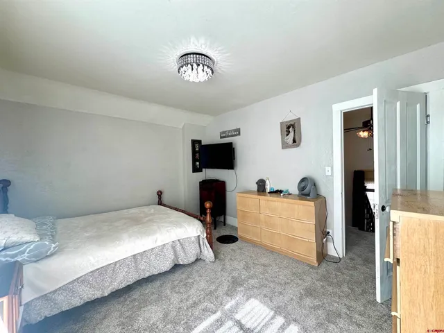 a bedroom with a bed and a television